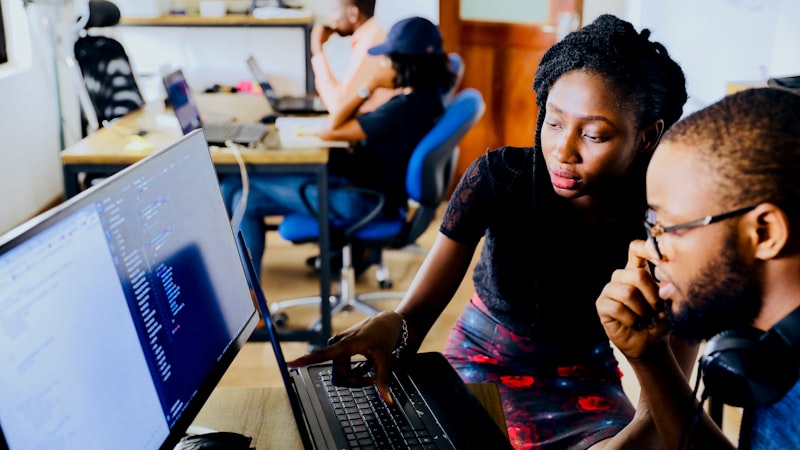 People collaborating around a laptop