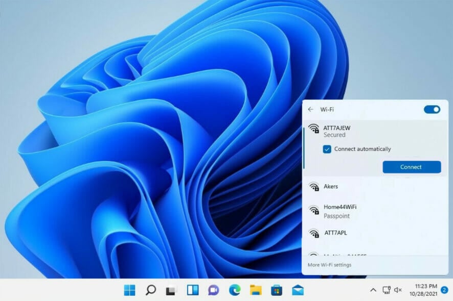 A Windows 11 desktop with the Wi-Fi panel open above the bottom right corner of the taskbar, showing a list of nearby networks, a ticked 'Connect automatically' box, and a Connect button.