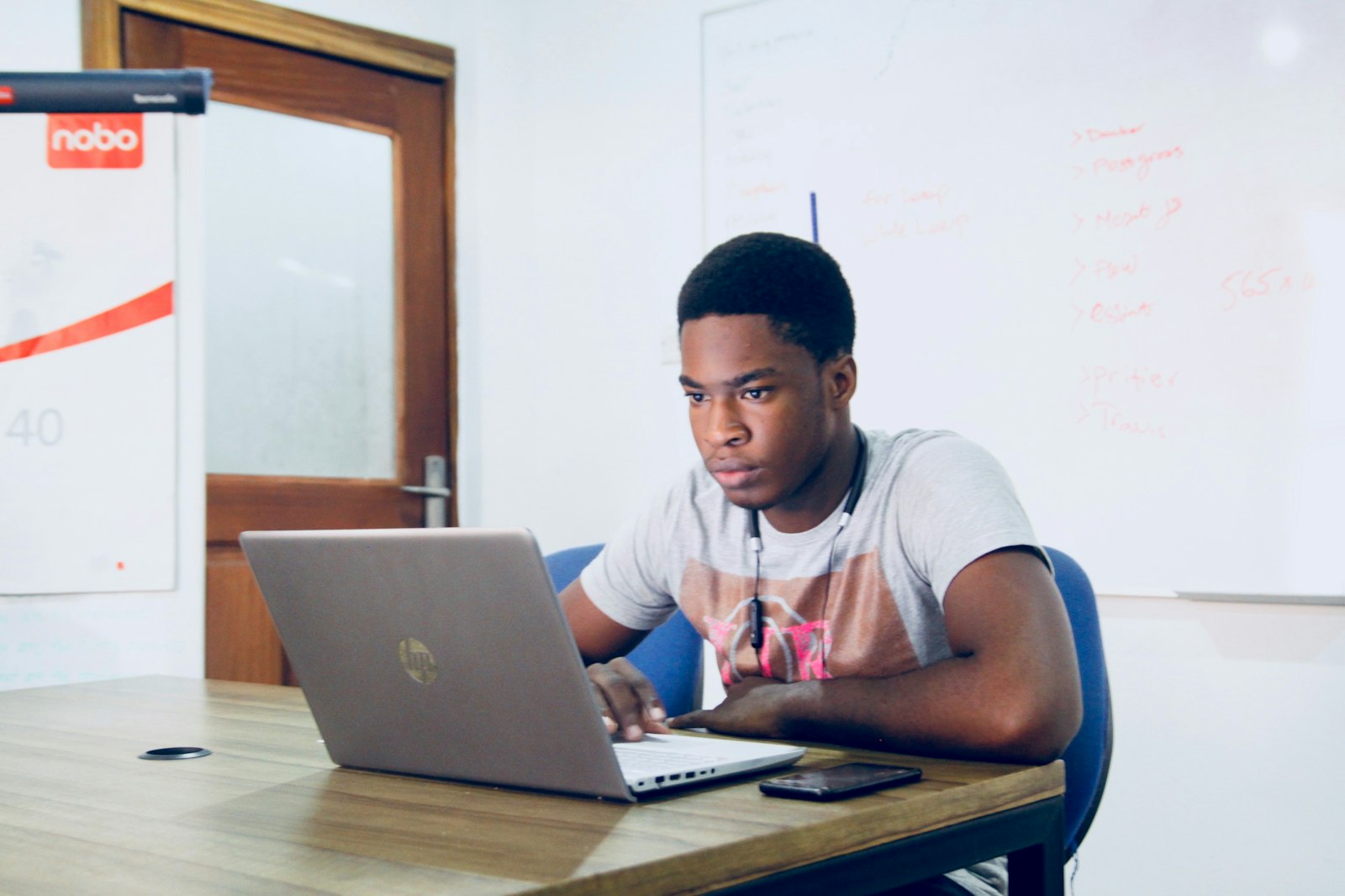 A young person studying on a refurbished HP laptop
