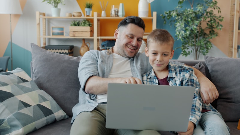 Father and son using a laptop together