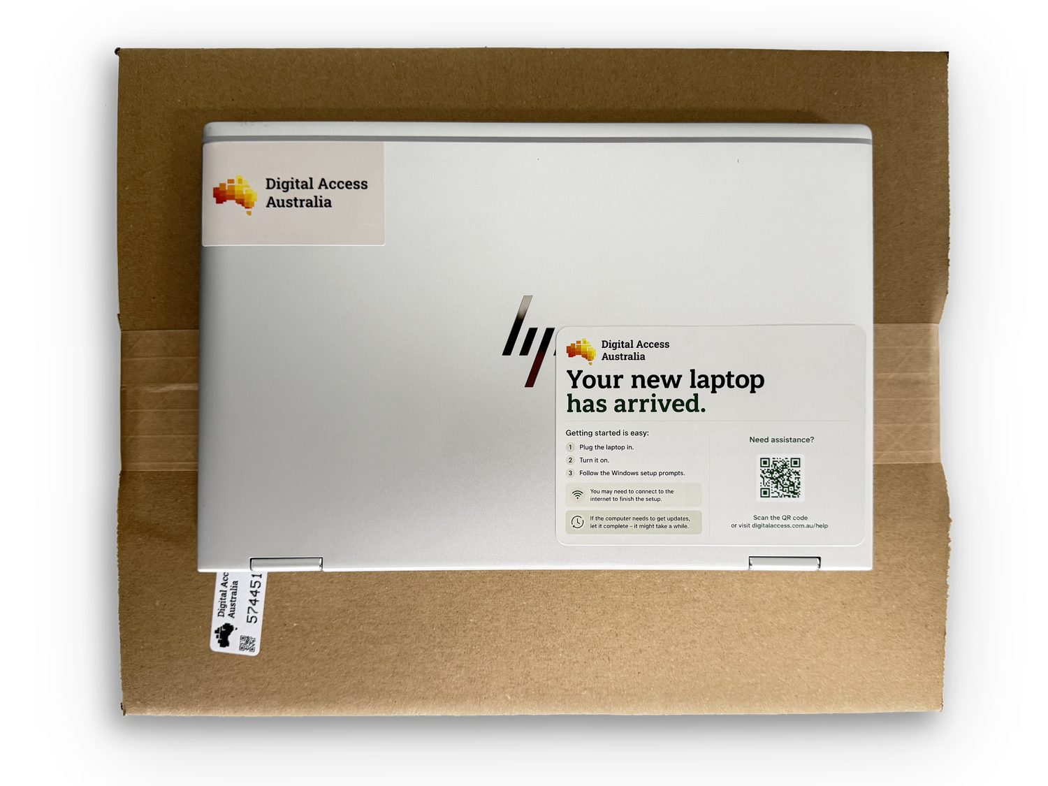 A boxed Digital Access Australia laptop with its 'Your new laptop has arrived' welcome card