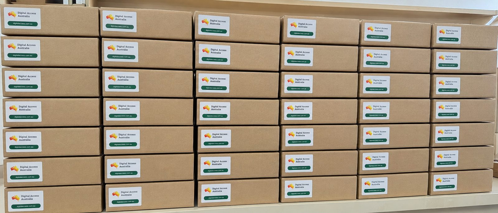 Shelves of boxed Digital Access Australia laptops ready to ship